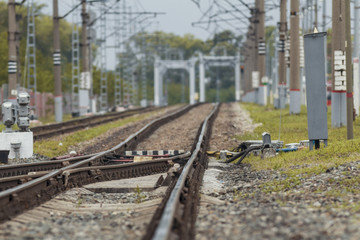 Railway tracks and bridge on crushed stone, telephoto
