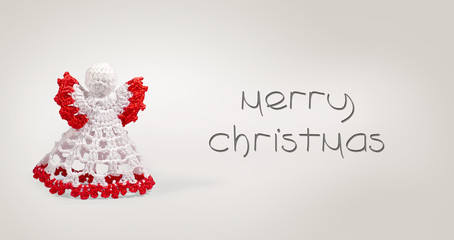 Greeting card with merry christmas writing with crochet angel