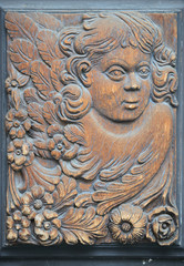 Close-up woodcarving detail on old house gate in Prague.
