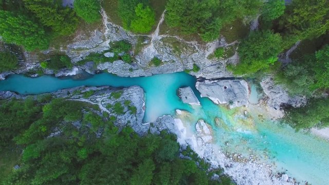 AERIAL top down view: flight over mountain river Soca. Camera moves from top to down