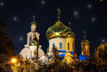 The Church of THE HOLY APOSTLES AND THE GOSPEL JOHN OF BOGHOSLOV in Pokrov city in Ukraire. Panorama of the holy Christian temple in the park at autumn night