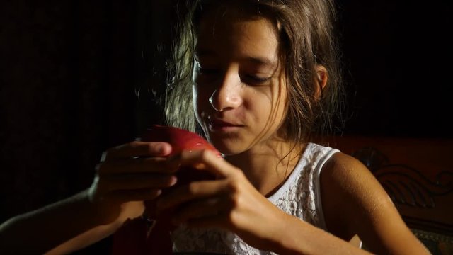 little hungry girl a vegetarian eating a pomegranate with greed at night. 4k, slow-motion