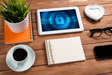 Web security and technology concept with tablet pc on wooden table