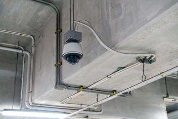 CCTV security camera installed on ceiling building.