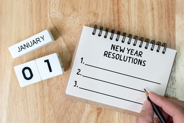 Top view notebook and calendar on wood table, New year resolution concept
