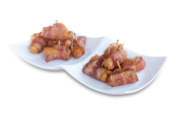Deep fried sausages rolled in bacon isolated on white background