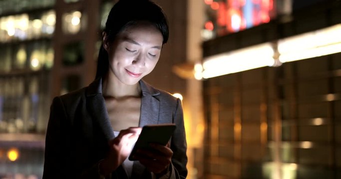 Business woman use of mobile phone at night