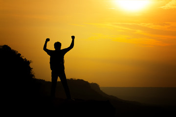 silhouette of man travel show arm up for achievements successful and celebrating success with sunrise