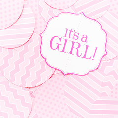 It's a girl sign at the baby shower party. Pink patterns background. Baby shower celebration concept