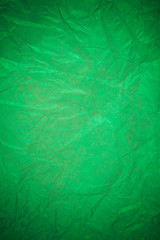 Crumpled green paper recycling background.