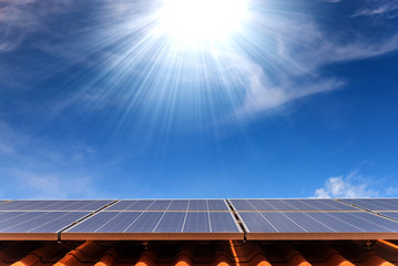 solar cell panel on roof house with strong sun and sky