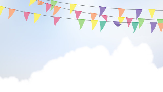 Celebration/party flags hanging in the air with bright blue sky and cloud background