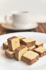 Wafers cubes with chocolate. on White plate