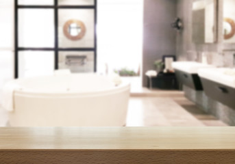 Fototapeta na wymiar Wood table top with blurred bathroom