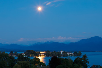 Sunset at Lake Chiemsee with Fraueninsel at Full Moon reflection an lake, long time exposure