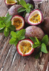 juicy fruit Granadilla with mint on a wooden table