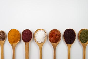Variety of indian spices and herbs isolated on white