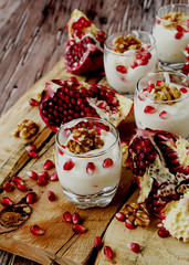 yogurt dessert with walnuts and pomegranate selective focus