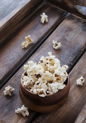 popcorn in a wooden plate on the background