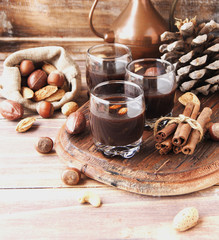 Hot chocolate in a glass cup with nuts and cinnamon