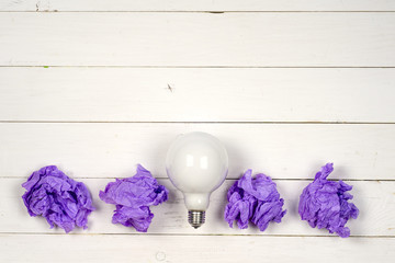 great idea concept with crumpled colorful paper and light bulb on light background