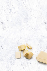 Organic Butter isolated on white marble kitchen top. Vertical composition. Top view
