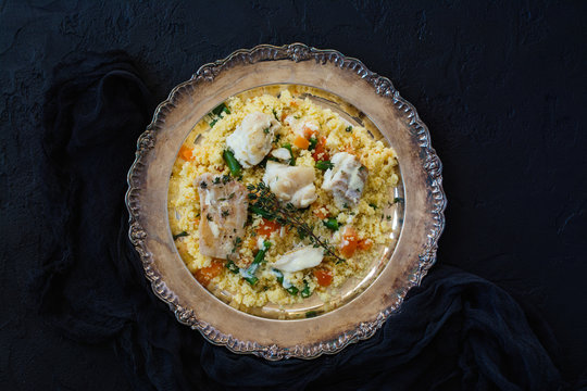 Couscous with fish and vegetables on sto