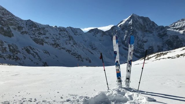 Ski in winter season, mountains and ski touring backcountry equipments on the top of snowy mountains in sunny day. South Tirol, Solda in Italy.
