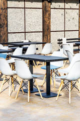 Table with armchairs in the bar. Outdoors.