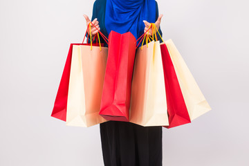 Close up of muslim woman with shopping bag on white background