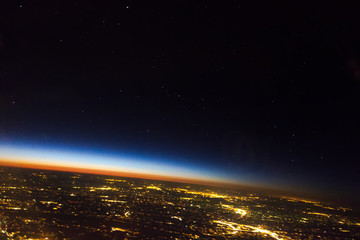 flying at night over cities below
