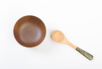 wooden spoon and bowl on white background