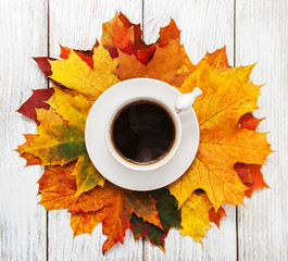 Cup of coffee and autumn leaves