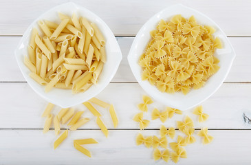 Two types of pasta on a white plate. 