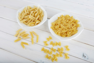 Two types of pasta on a white plate. 