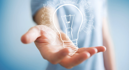 Businessman holding renewable eco lightbulb sketch