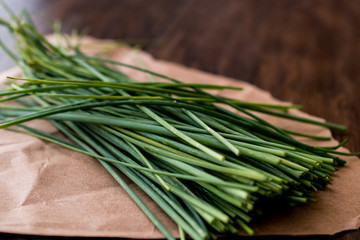 Fresh Chives / Siniklav or Frenk Sogani on wooden surface.