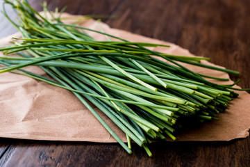 Fresh Chives / Siniklav or Frenk Sogani on wooden surface.