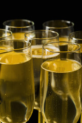 Glasses of champagne on isolated on the black background