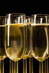Glasses of champagne on isolated on the black background