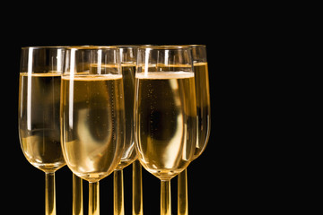 Glasses of champagne on isolated on the black background