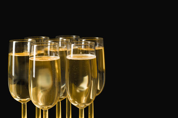 Glasses of champagne on isolated on the black background