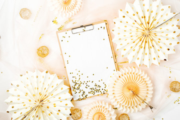 Clipboard and  golden decorations. Flat lay, top view trendy holiday concept.