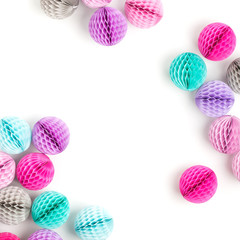 Honeycomb balls decorations background. Pink, lilac and turquoise paper pom pom on a white. Flat lay. Holiday concept