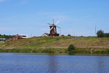 Colorful views of the windmill and the river.  River Sinyachikha, Nizhnyaya Sinyachikha, Sverdlovsk oblast, Russia.