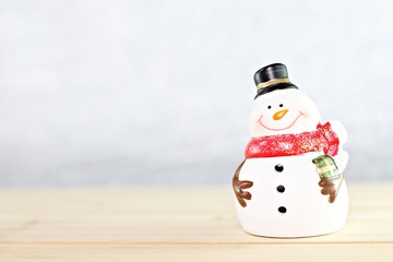 Happy New Year, Merry Christmas, celebration or holiday background concept : Santa Claus doll on wooden table and bright abstract background