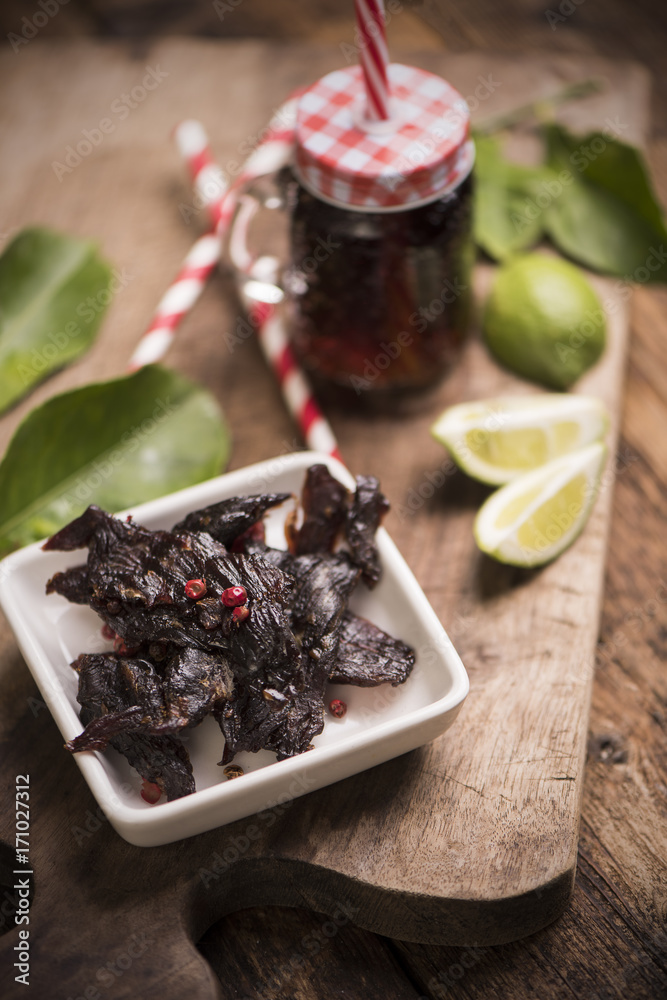 Wall mural Beef Jerky on wooden background