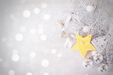 Happy New Year, Merry Christmas, celebration or holiday background concept : Yellow star and shiny silver ornaments on bright abstract background bokeh, Top view or flat lay with copy space
