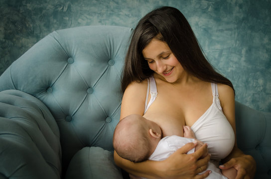 Breastfeeding baby. Mother nursing her child. Newborn eat breast milk.