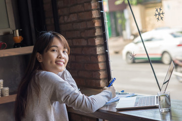 Smiling Asian freelancer enjoy her working day